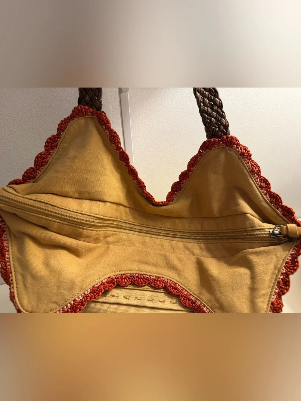 The Sak tan canvas Indio hobo bag with braided brown straps and crochet trim